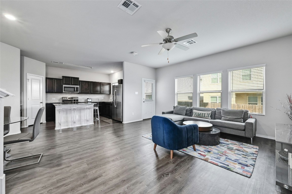 100 Comet Drive, Unit 1I Jarrell, TX 76537 - Photo 2 of 25 a living room with furniture and a kitchen view