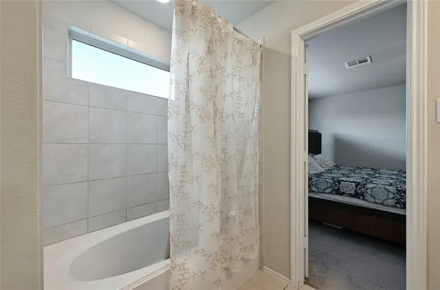 a bathroom with a tub and shower