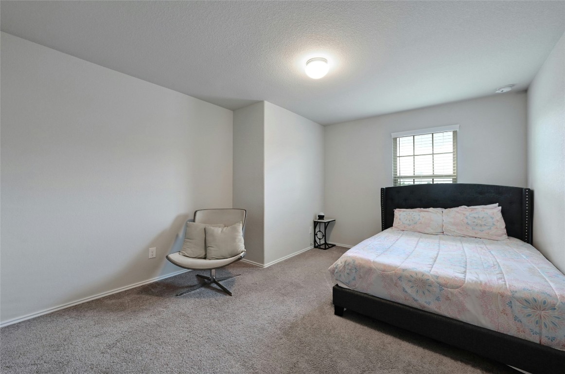 100 Comet Drive, Unit 1I Jarrell, TX 76537 - Photo 9 of 25 a bedroom with a bed and a window