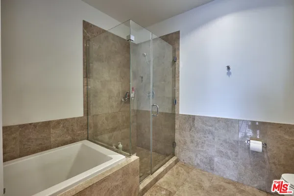 a bathroom with a bathtub and shower