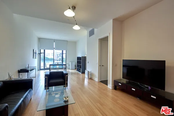 a view of a livingroom with furniture and a flat screen tv