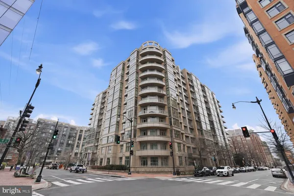 a view of a tall building next to a road