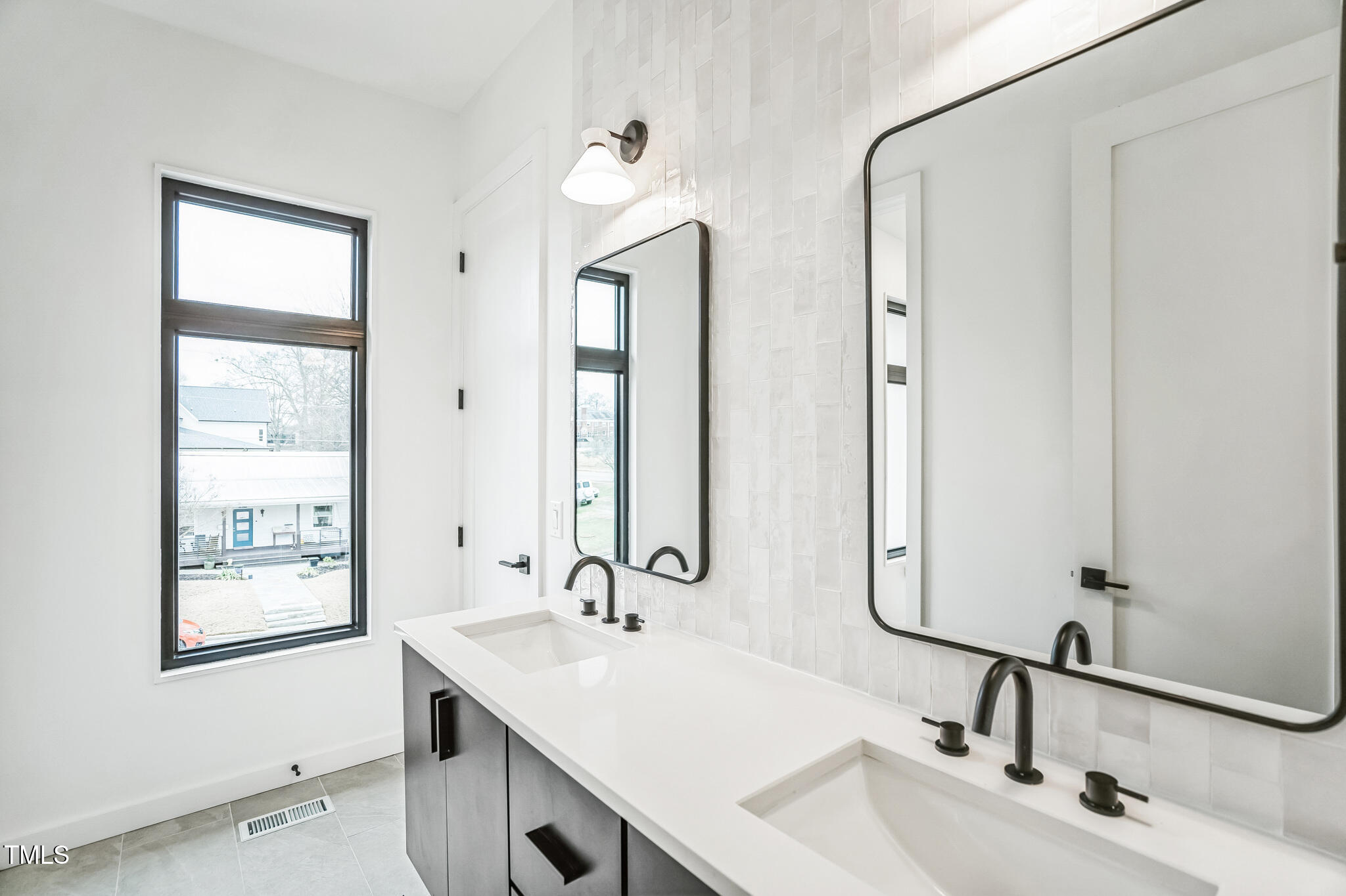 715 1/2 Van Buren Road Raleigh, NC 27604 - Photo 20 of 23 a bathroom with double vanity sinks and a mirror