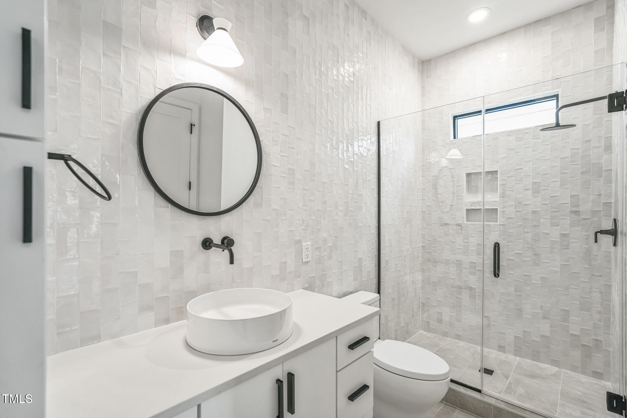 715 1/2 Van Buren Road Raleigh, NC 27604 - Photo 7 of 23 a bathroom with a toilet a sink and a mirror