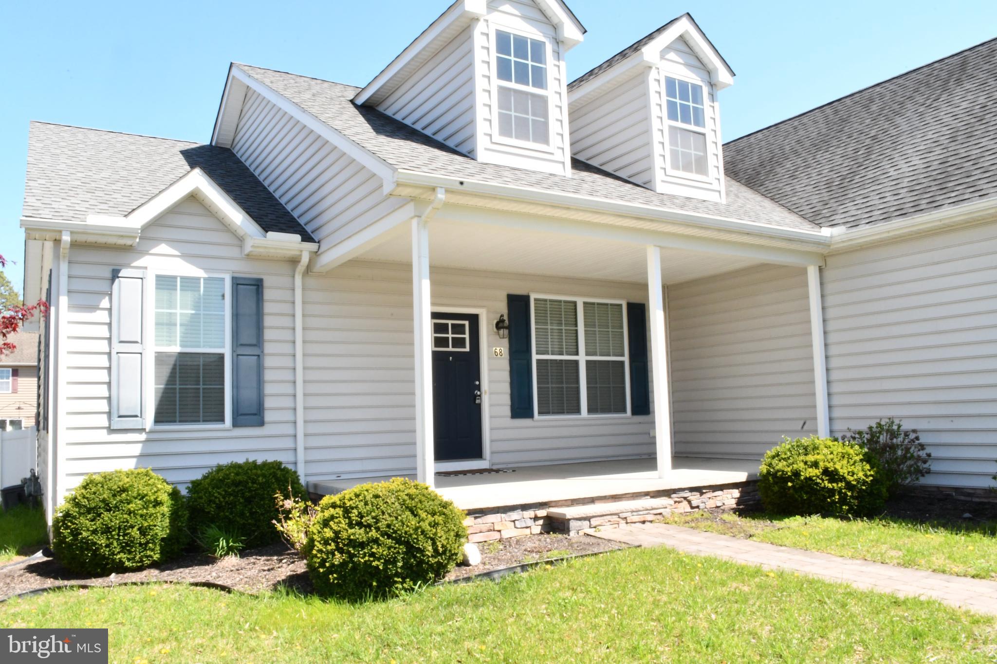 68 Split Oak Drive Felton, DE 19943 - Photo 2 of 22 a view of a house with potted plants and a large tree