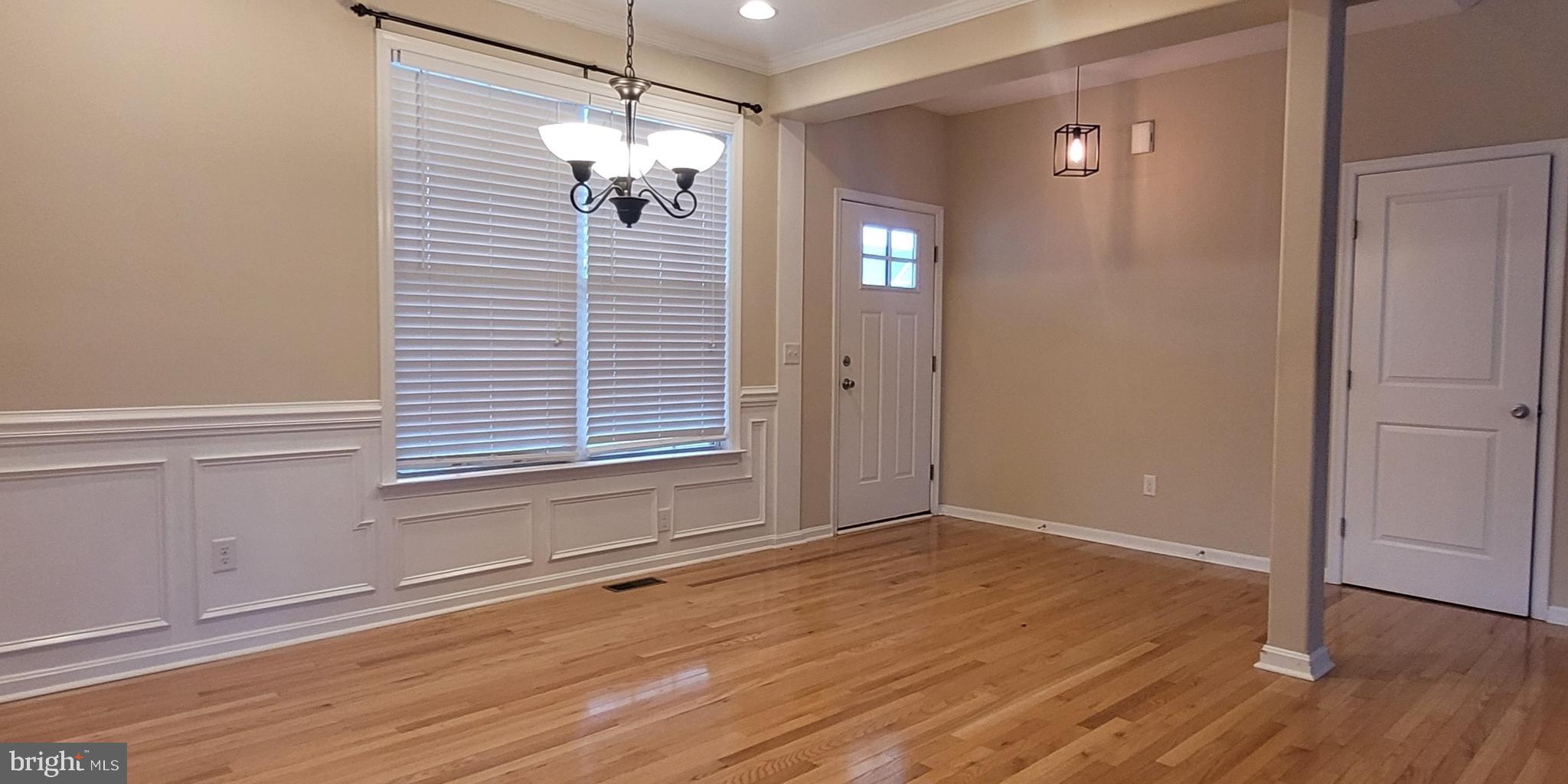 68 Split Oak Drive Felton, DE 19943 - Photo 3 of 22 an empty room with wooden floor and windows