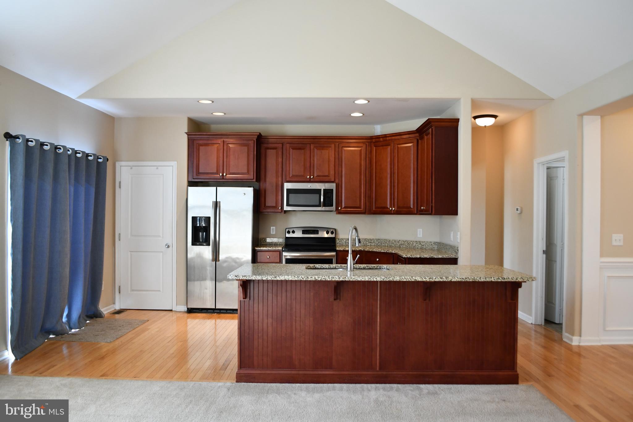 68 Split Oak Drive Felton, DE 19943 - Photo 6 of 22 a kitchen with stainless steel appliances granite countertop a refrigerator and a stove top oven