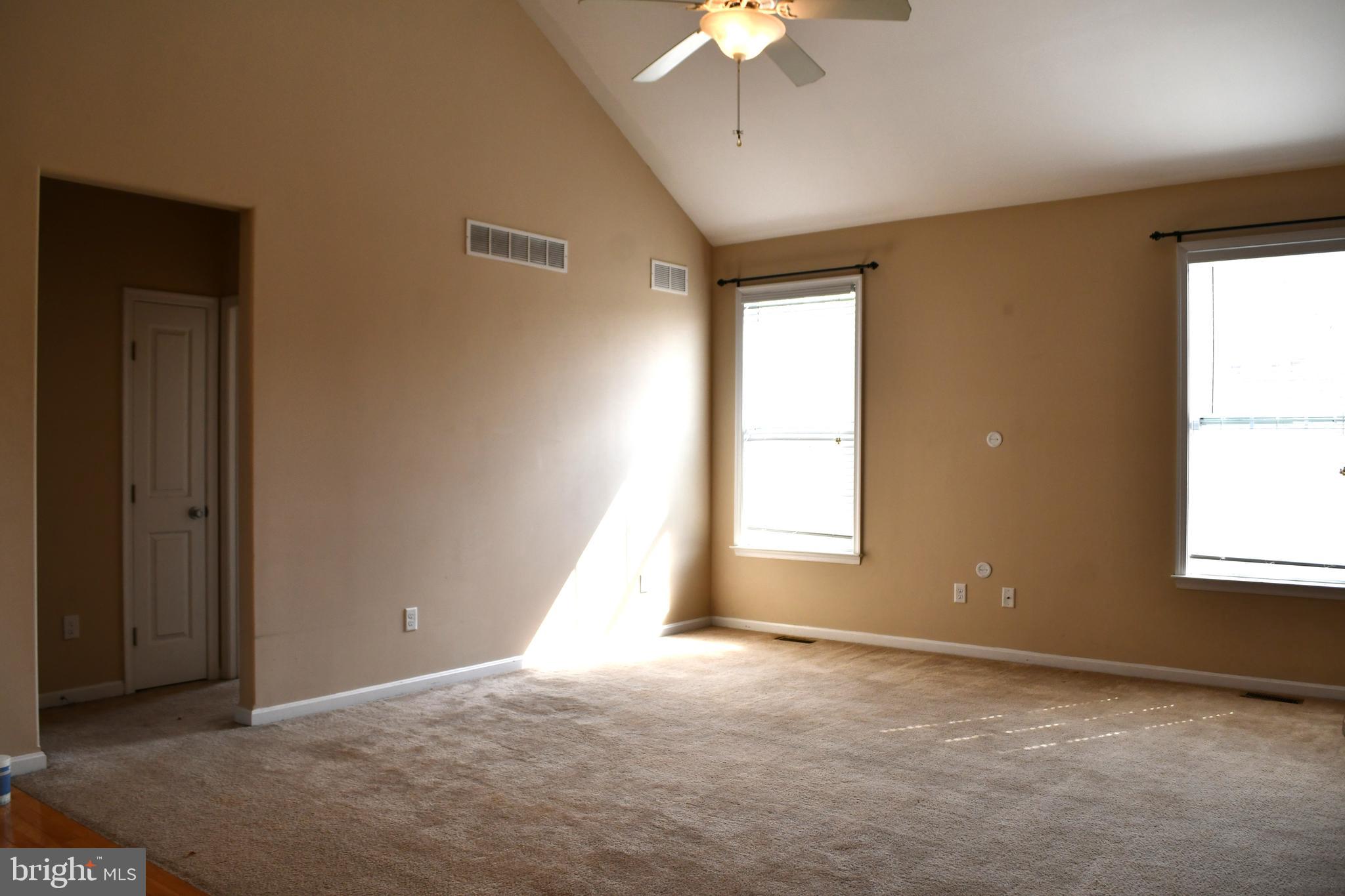 68 Split Oak Drive Felton, DE 19943 - Photo 7 of 22 an empty room with windows and chandelier fan