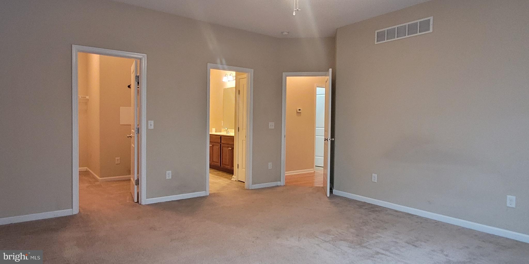 68 Split Oak Drive Felton, DE 19943 - Photo 8 of 22 an empty room with windows and bathroom view