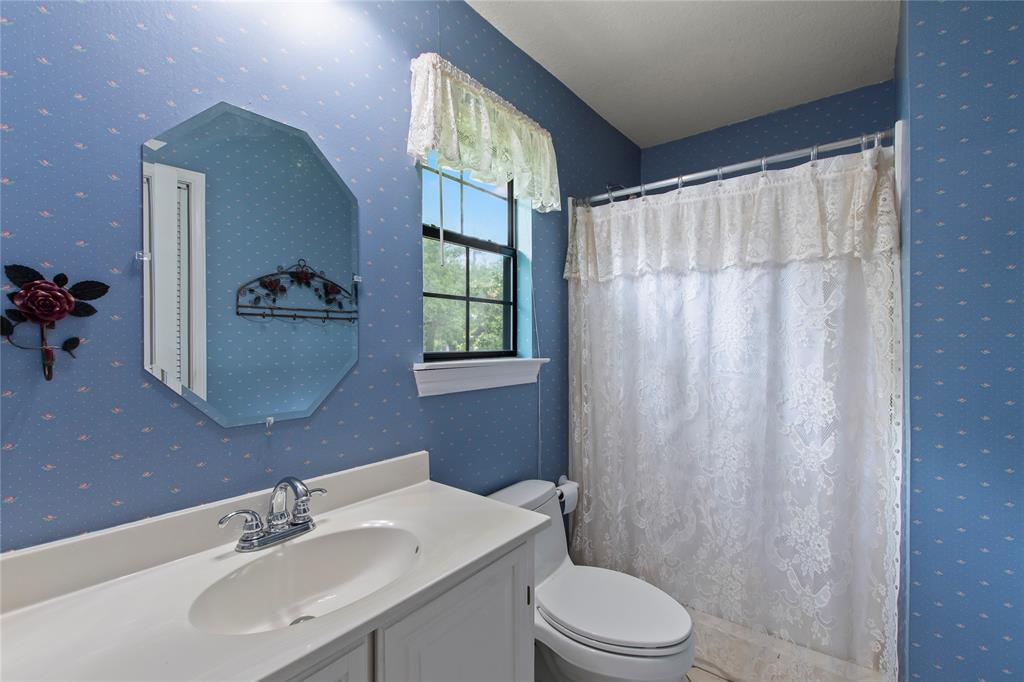 455 Stirrup Ranch Road Trinidad, TX 75163 - Photo 16 of 20 a bathroom with a sink a toilet and shower