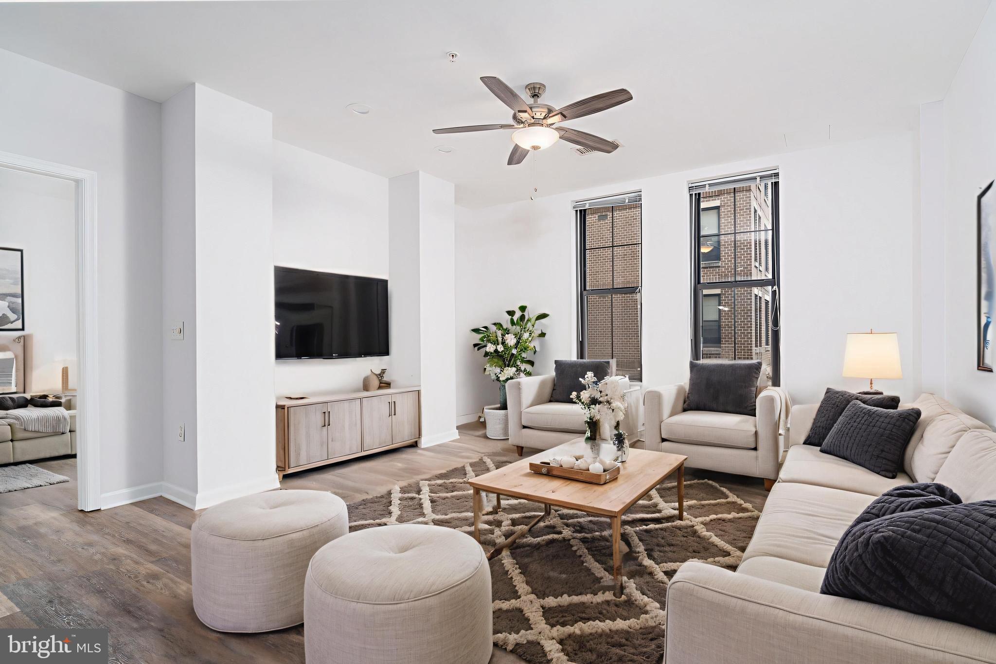 444 West Broad Street, Unit 401 Falls Church, VA 22046 - Photo 1 of 43 a living room with furniture and a flat screen tv