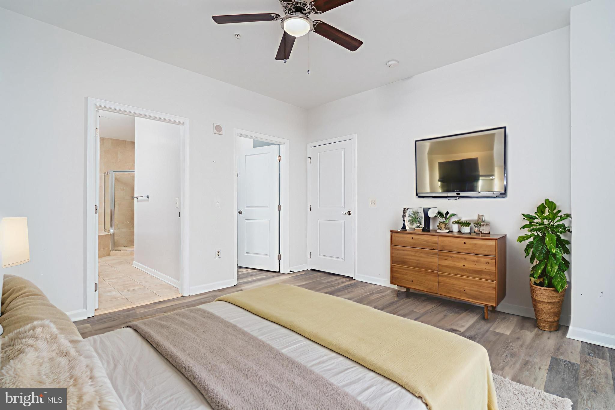 444 West Broad Street, Unit 401 Falls Church, VA 22046 - Photo 12 of 43 a bedroom with a bed and a flat screen tv