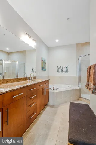 a spacious bathroom with a tub sink and mirror