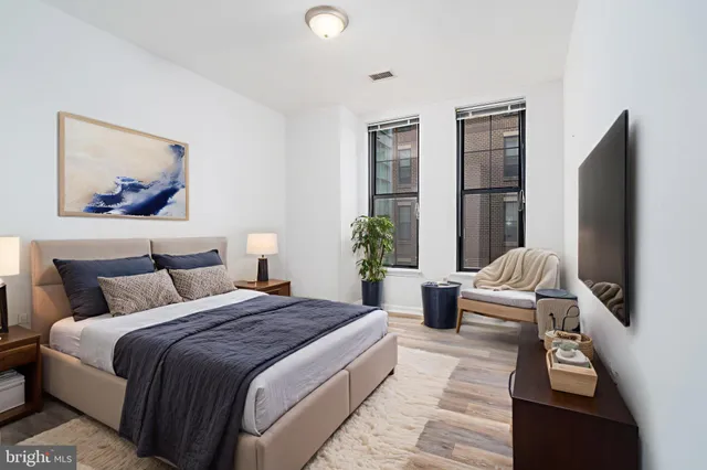a bedroom with bed and glass door