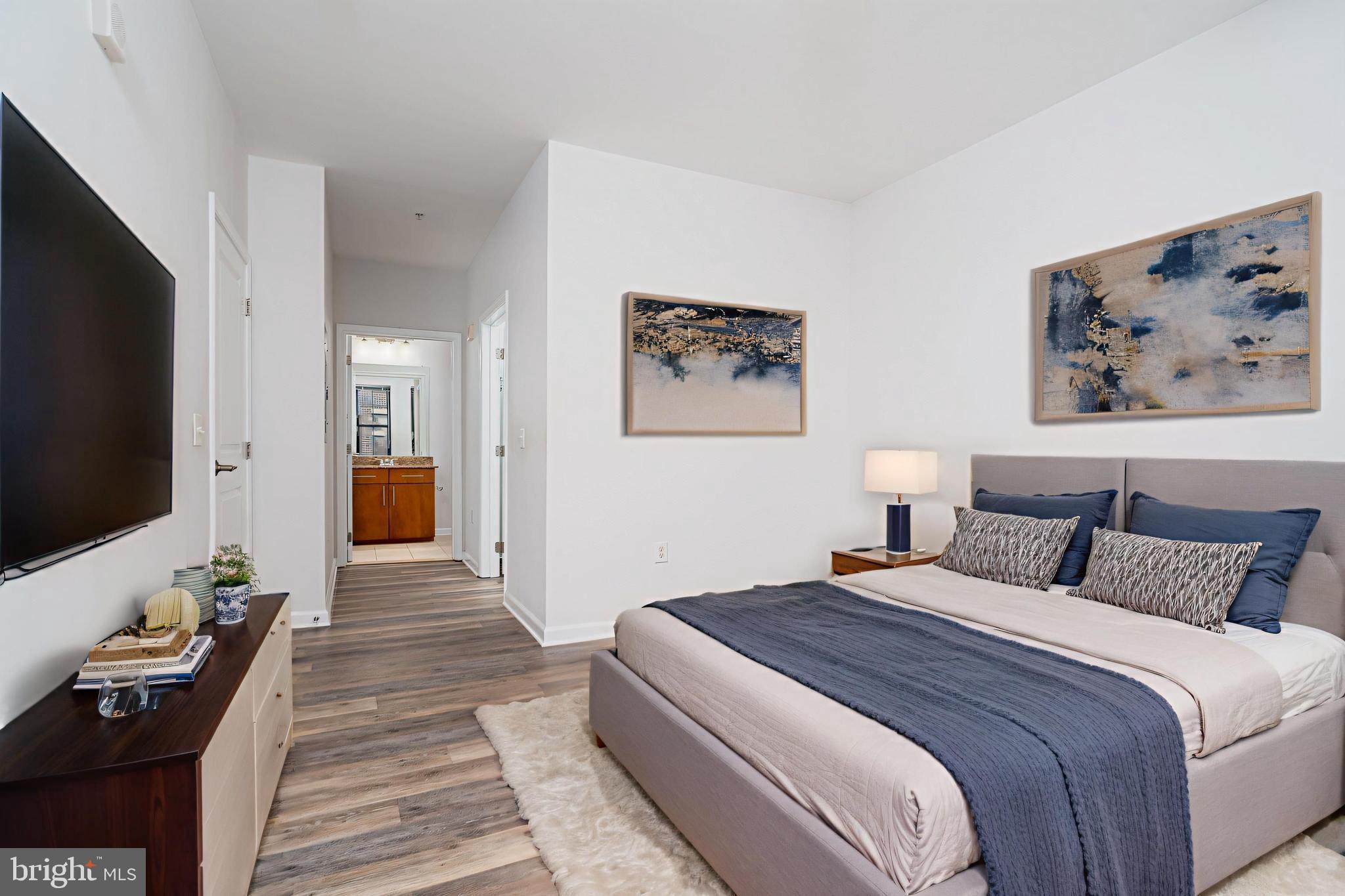 444 West Broad Street, Unit 401 Falls Church, VA 22046 - Photo 20 of 43 a bedroom with a bed and a flat screen tv