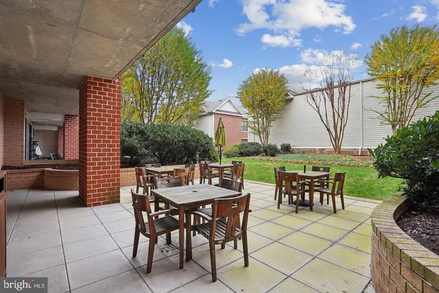 a patio with a patio table and chairs