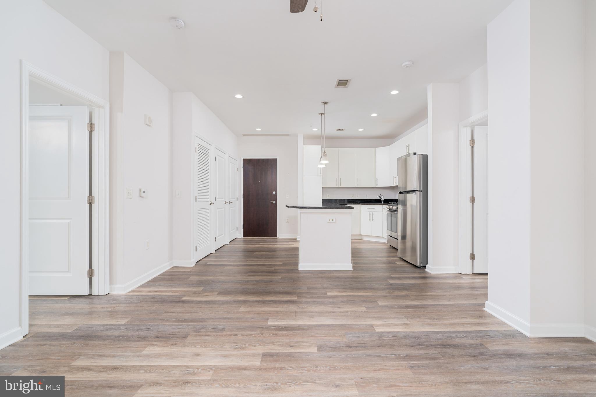 444 West Broad Street, Unit 401 Falls Church, VA 22046 - Photo 3 of 43 a view of kitchen with wooden floor