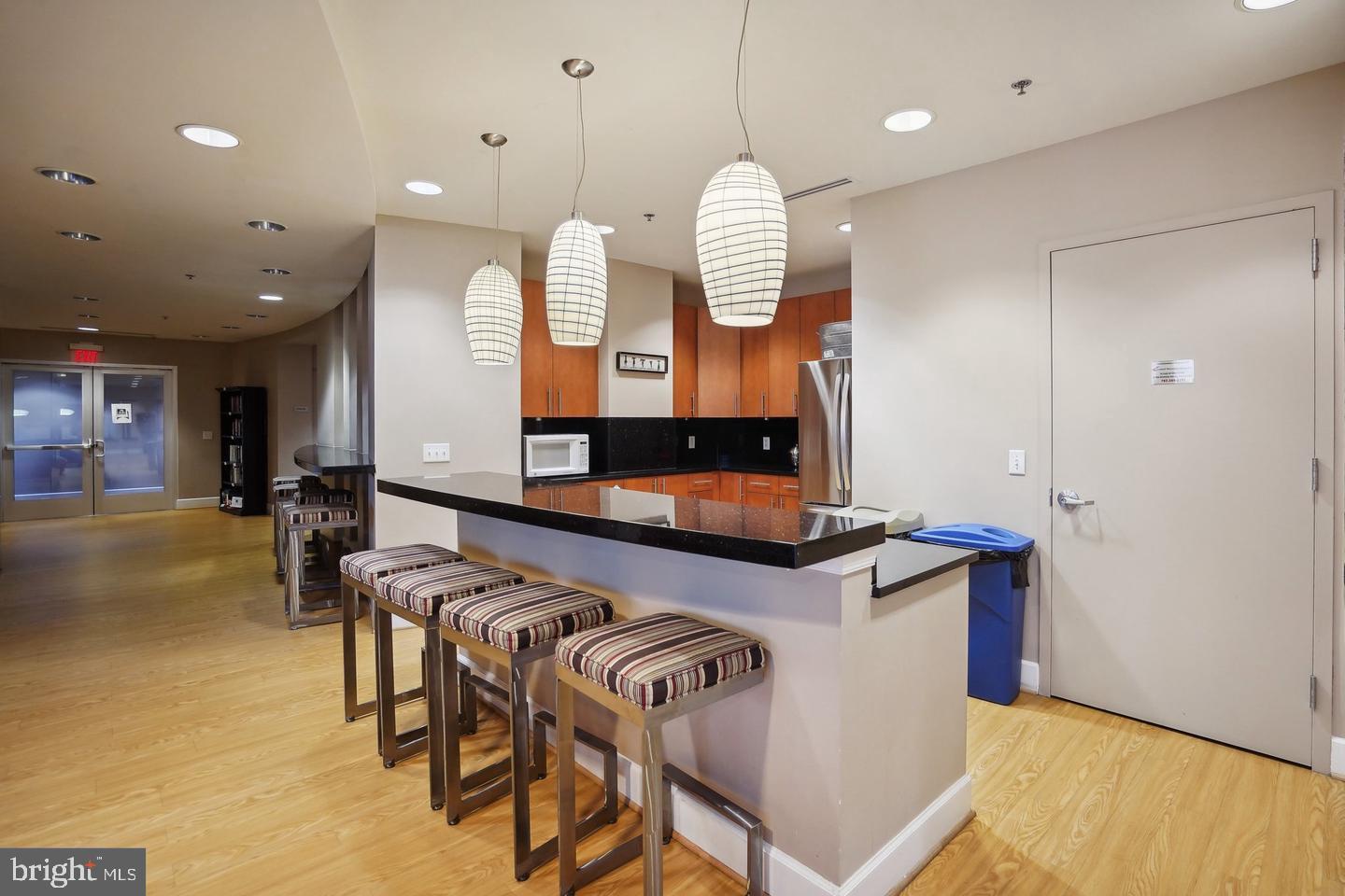 444 West Broad Street, Unit 401 Falls Church, VA 22046 - Photo 36 of 43 a large kitchen with a table and chairs in it