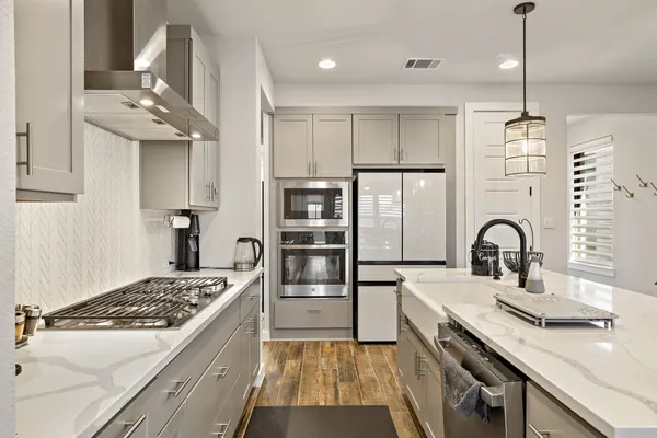 a kitchen with a sink stainless steel appliances and cabinets