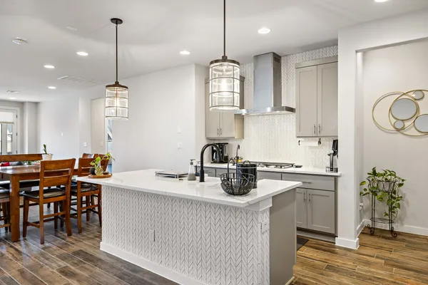 a kitchen with kitchen island granite countertop a sink a counter space appliances and cabinets