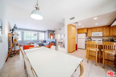 a view of a dining room with furniture and a floor to ceiling window