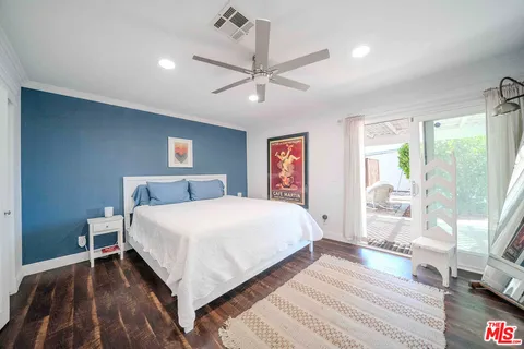 a bedroom with a bed and a view of room