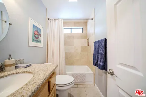 a bedroom with a bed and a table