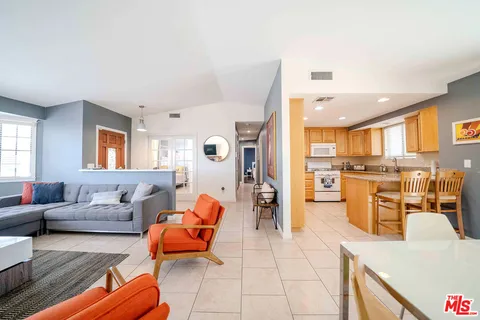 a kitchen with stainless steel appliances granite countertop a refrigerator sink stove and granite counter top