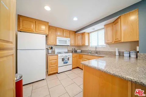 a kitchen with stainless steel appliances granite countertop a sink and cabinets