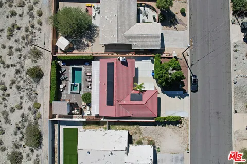 an aerial view of a house with swimming pool