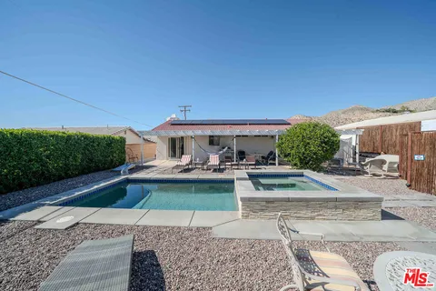 a wooden bench sitting in the middle of a backyard