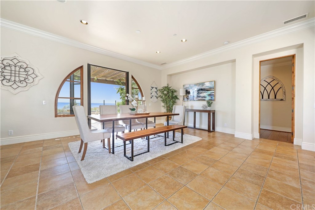 53 Overlook Drive Newport Coast, CA 92657 - Photo 11 of 28 The huge dining room offers crown molding, recessed lighting, fresh paint and Travertine tile floors.