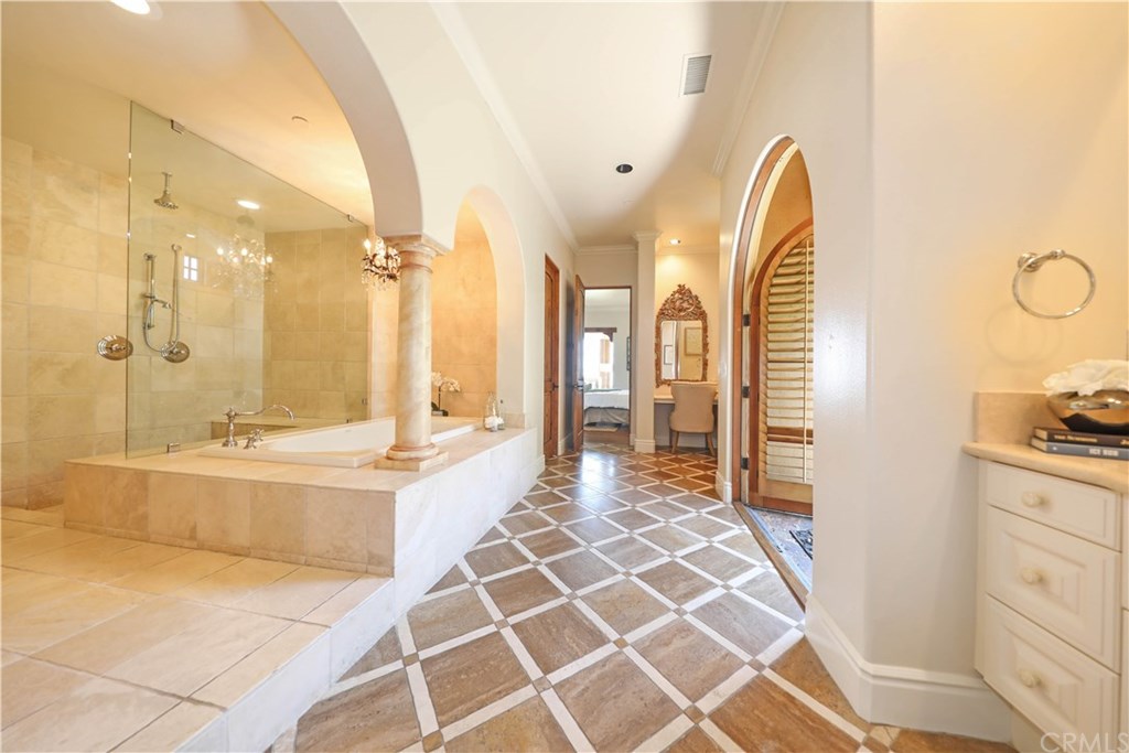 53 Overlook Drive Newport Coast, CA 92657 - Photo 19 of 28 Stunning master bathroom offers a huge walk-in shower, jetted tub, dual vanities, Italian Porcelain Parquet flooring and French doors to side yard with a Fiore fountain.