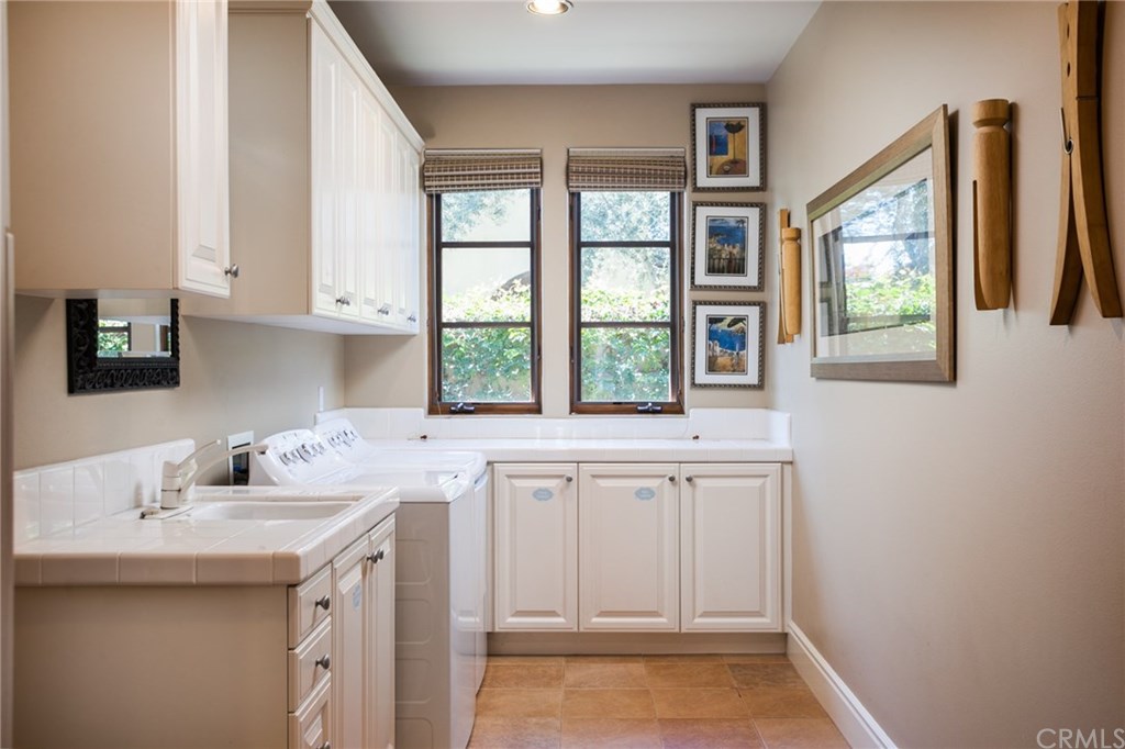 53 Overlook Drive Newport Coast, CA 92657 - Photo 22 of 28 The laundry room is extra large and offers ample cabinetry and a sink.