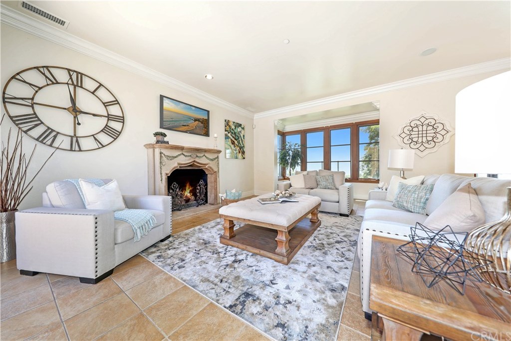53 Overlook Drive Newport Coast, CA 92657 - Photo 7 of 28 The family room boasts a cozy gas fireplace, crown molding, Travertine Tile Floors, Speakers for Surround Sound and ocean views!