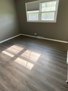 15500 Wolf Road Orland Park, IL 60467 - Photo 13 of 24 an empty room with wooden floor and windows