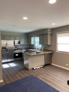 15500 Wolf Road Orland Park, IL 60467 - Photo 17 of 24 a large kitchen with a large window and stainless steel appliances