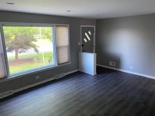 an empty room with wooden floor and closet
