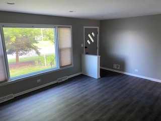 15500 Wolf Road Orland Park, IL 60467 - Photo 20 of 24 an empty room with wooden floor and windows