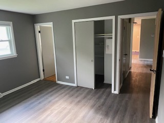 15500 Wolf Road Orland Park, IL 60467 - Photo 21 of 24 an empty room with wooden floor and closet