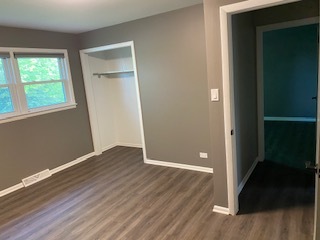 15500 Wolf Road Orland Park, IL 60467 - Photo 22 of 24 an empty room with wooden floor and windows