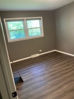 15500 Wolf Road Orland Park, IL 60467 - Photo 23 of 24 an empty room with wooden floor and windows