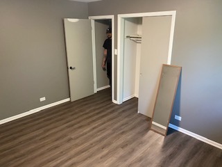 15500 Wolf Road Orland Park, IL 60467 - Photo 24 of 24 an empty room with wooden floor and a bathroom