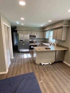 15500 Wolf Road Orland Park, IL 60467 - Photo 6 of 24 a living room with stainless steel appliances furniture refrigerator and a wooden floor
