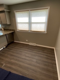 15500 Wolf Road Orland Park, IL 60467 - Photo 7 of 24 a view of an empty room with wooden floor and a window