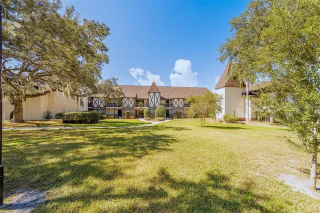 a swimming pool with outdoor seating and yard