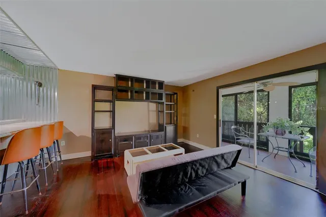 a living room with furniture a table and wooden floor