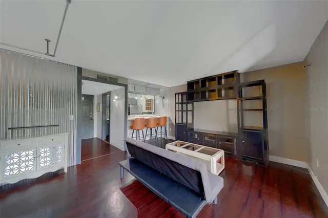 a very nice looking room with wooden floor and a bathroom