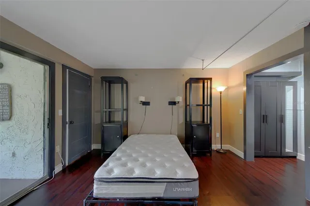 a view of a room with wooden floor and windows