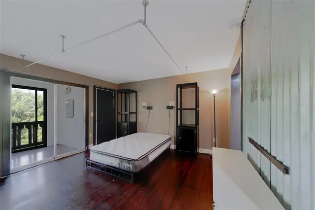 a view of a hallway with wooden floor and closet